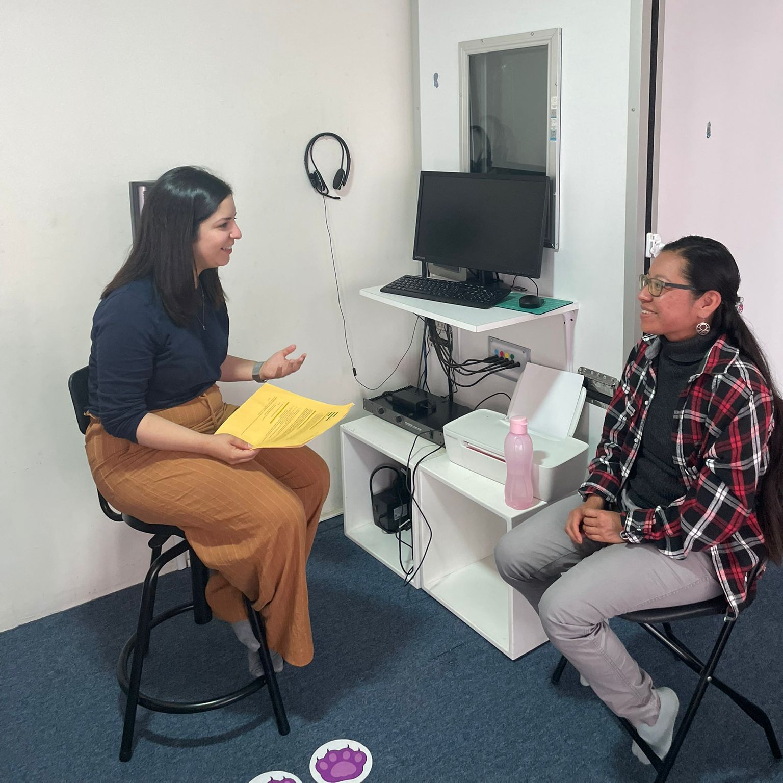 CERCA Lab member speaking to a client inside of a doctors room.